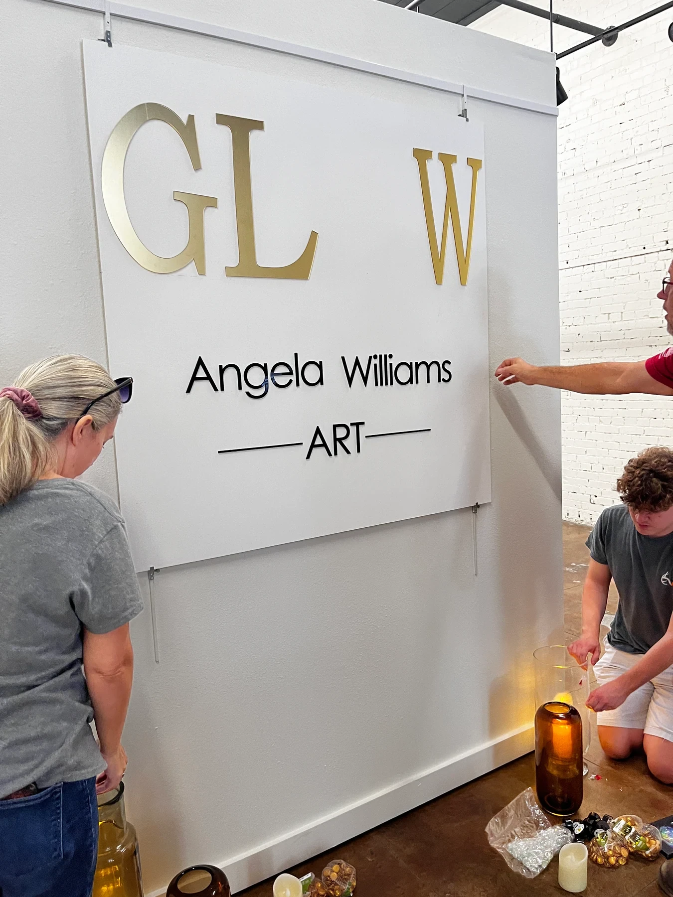 The GLOW sign and candle display being arranged before the celebration.