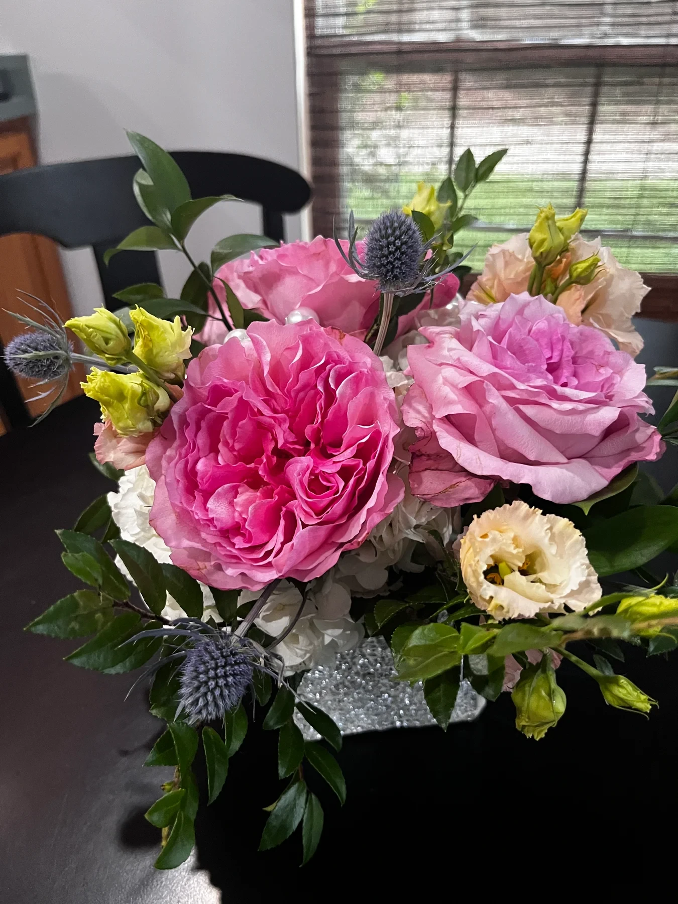 A close view of pink roses and other flowers from the celebration.