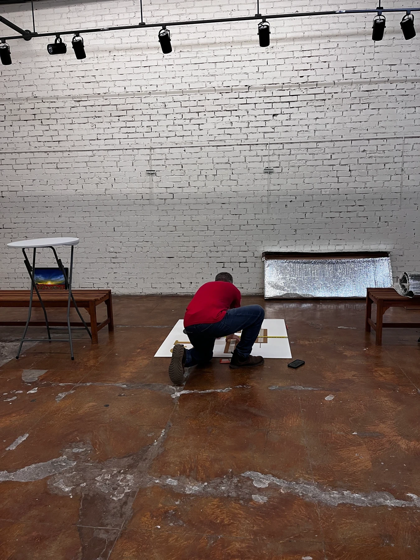 A guest assembling the exhibition display on the gallery floor.