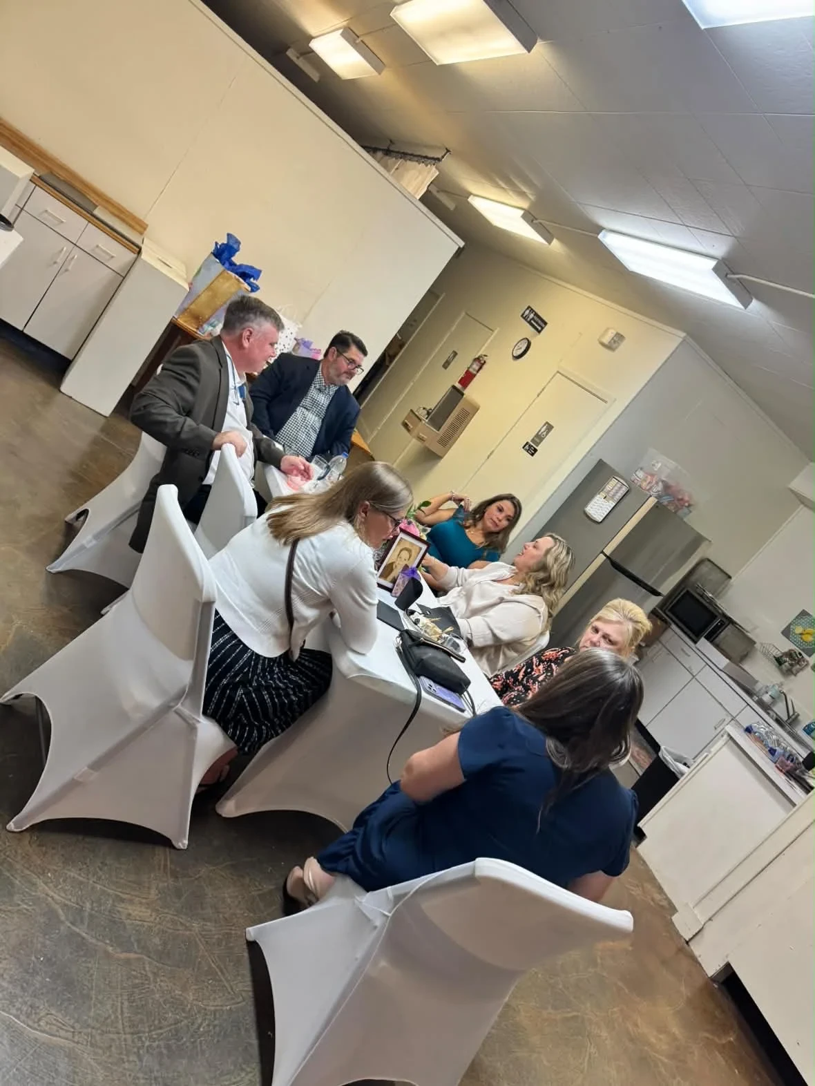 Guests seated together around a table at the celebration.